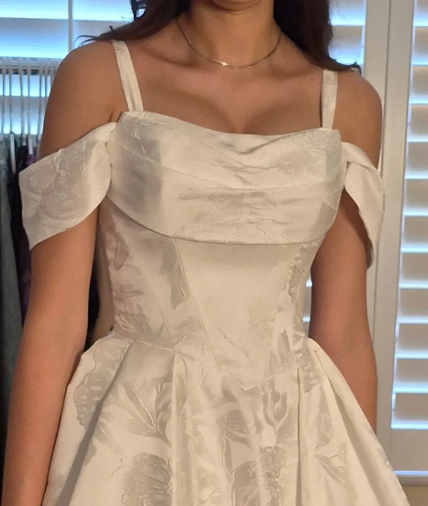 Close-up of a structured jacquard bodice with folded neckline, curved seams and fitted waist